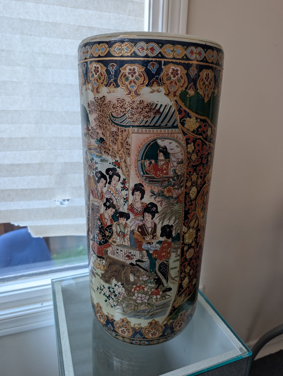 Decorative cylindrical vase with figures and floral patterns