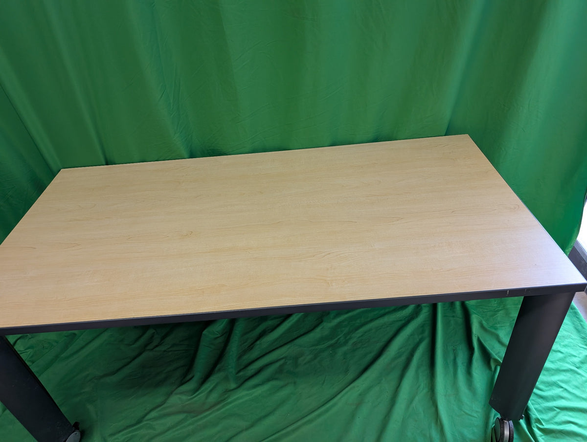 Woodgrain rectangular table with dark metal legs and casters, view 2