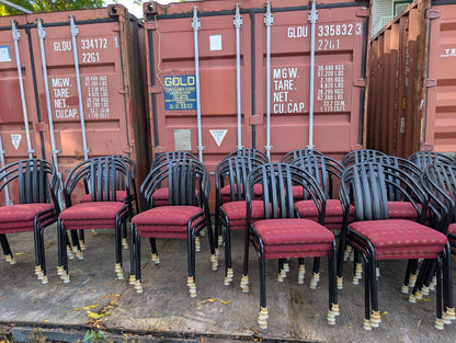 Red patterned upholstered stacking chair with black metal frame, stacked chairs showing bulk quantity