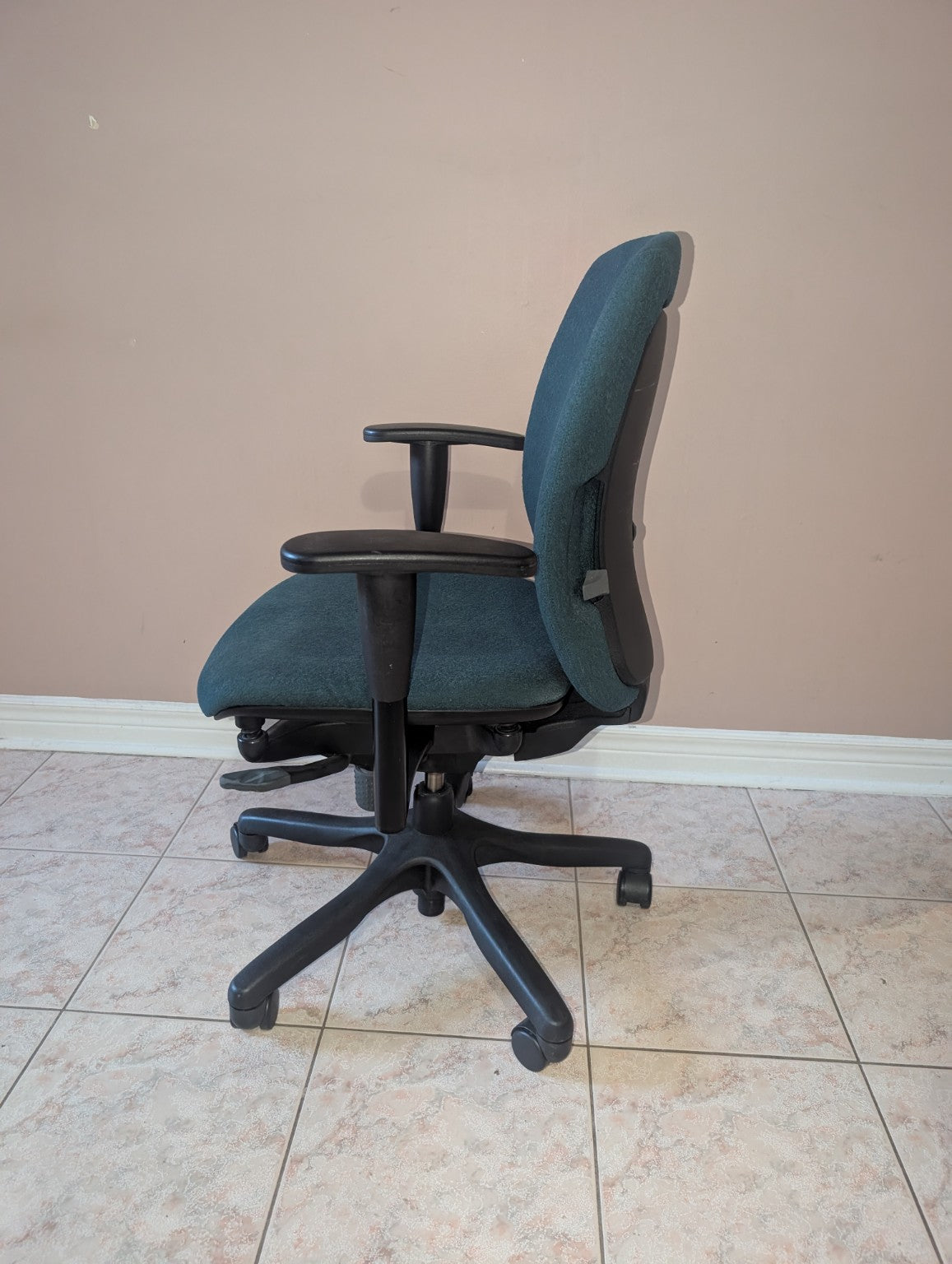 Dark green Teknion Amicus fabric office chair, side view