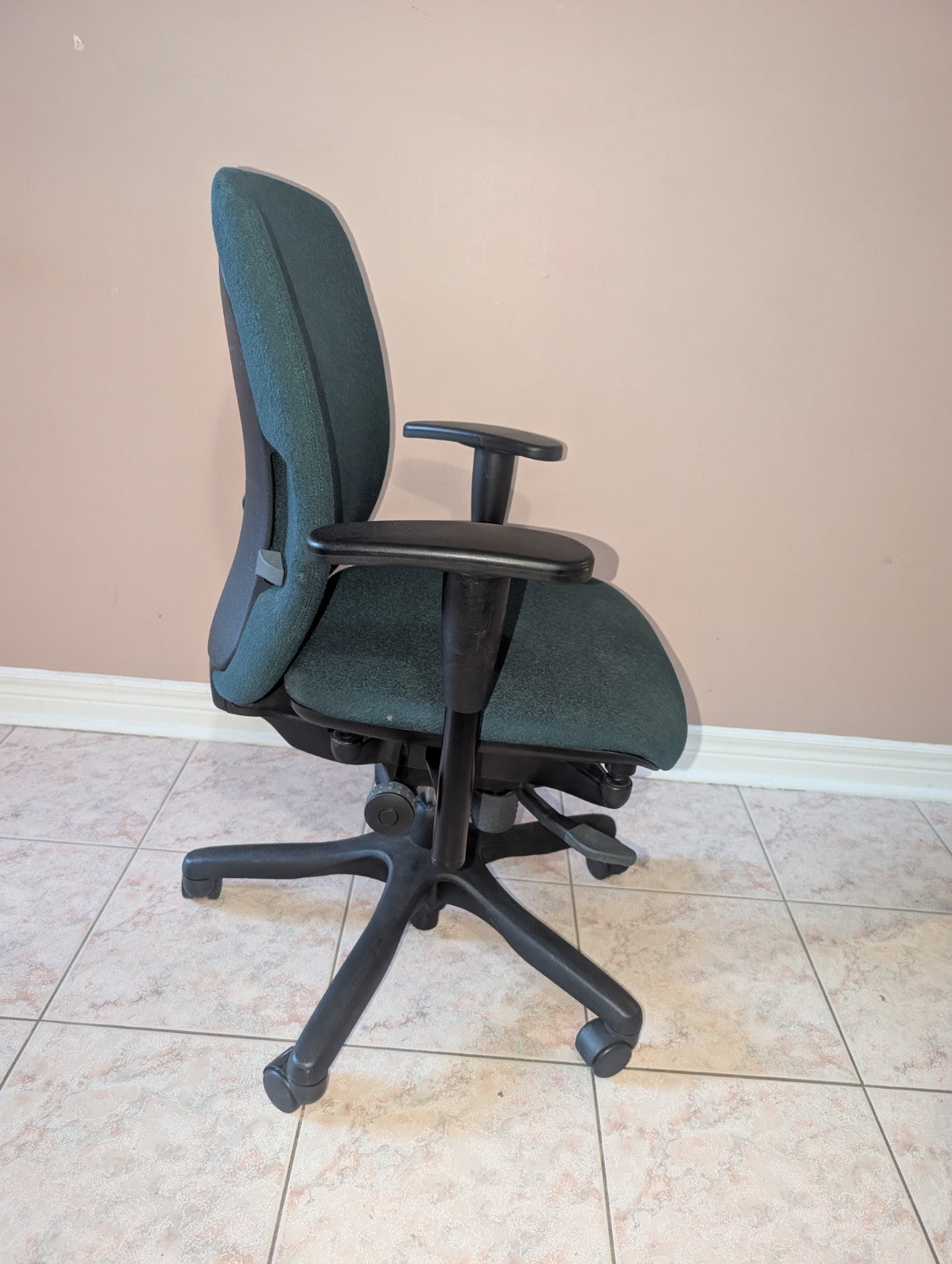 Dark green Teknion Amicus fabric office chair, opposite side view
