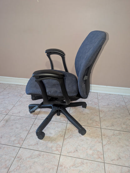 Teknion Amicus office chair with blue-grey patterned fabric, opposite side view