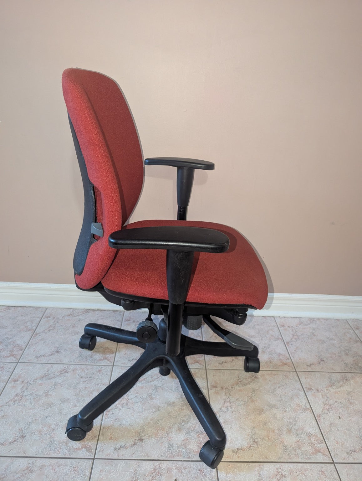 Red Teknion Amicus fabric office chair, opposite side view