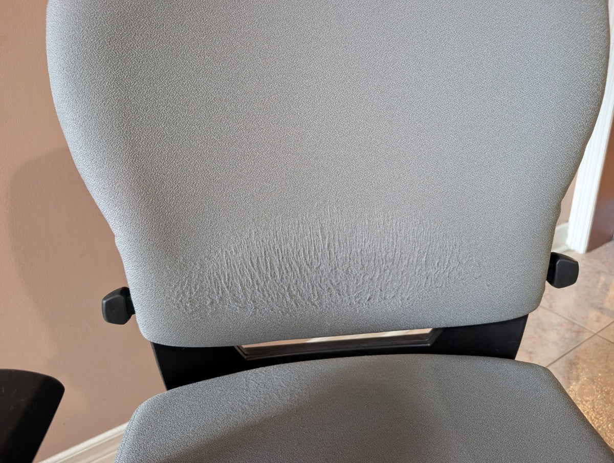 Close-up of visible fabric wear on Teknion Savera Synchro backrest