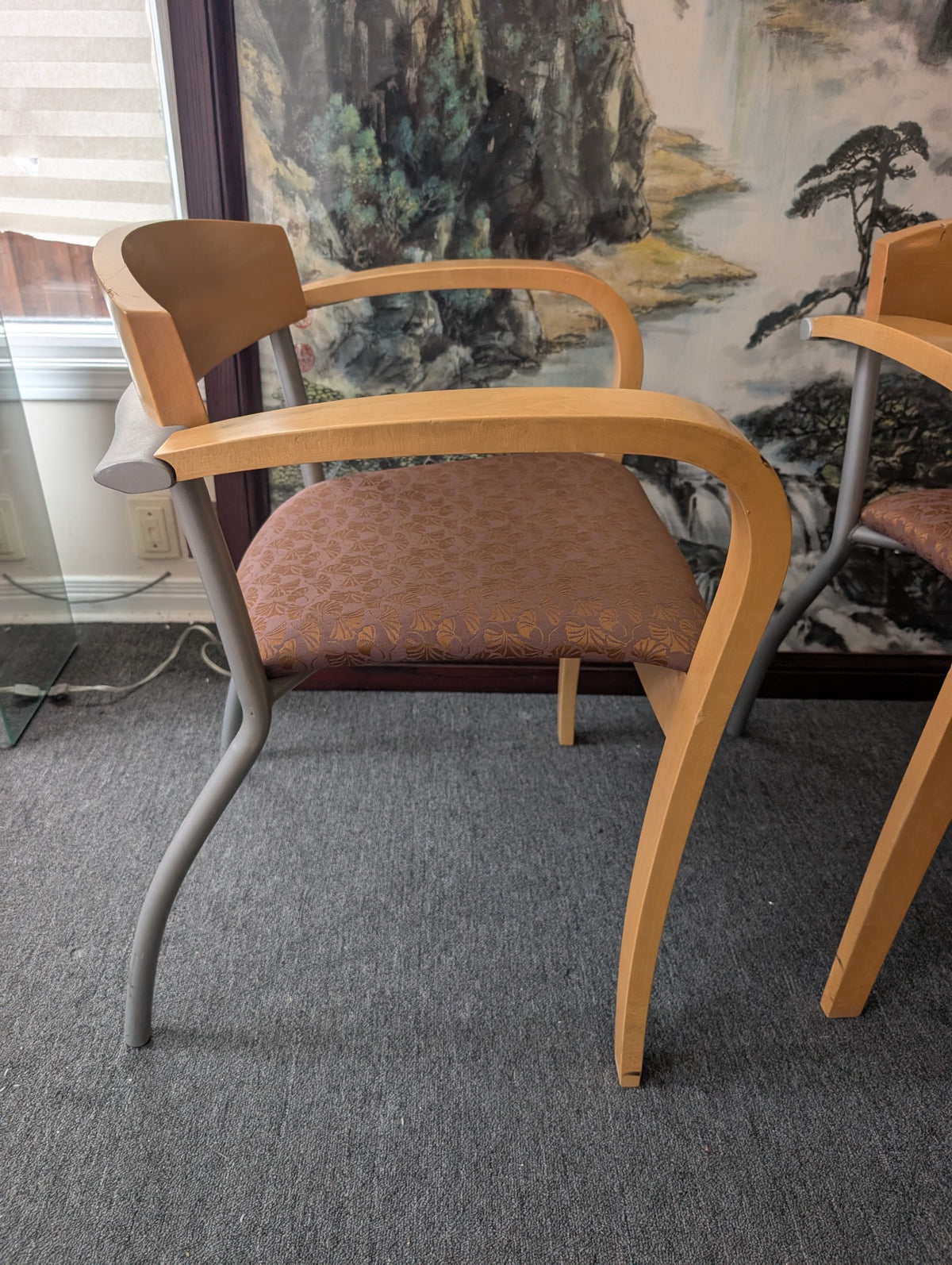 Wood arm guest chair with grey metal rear legs, side view