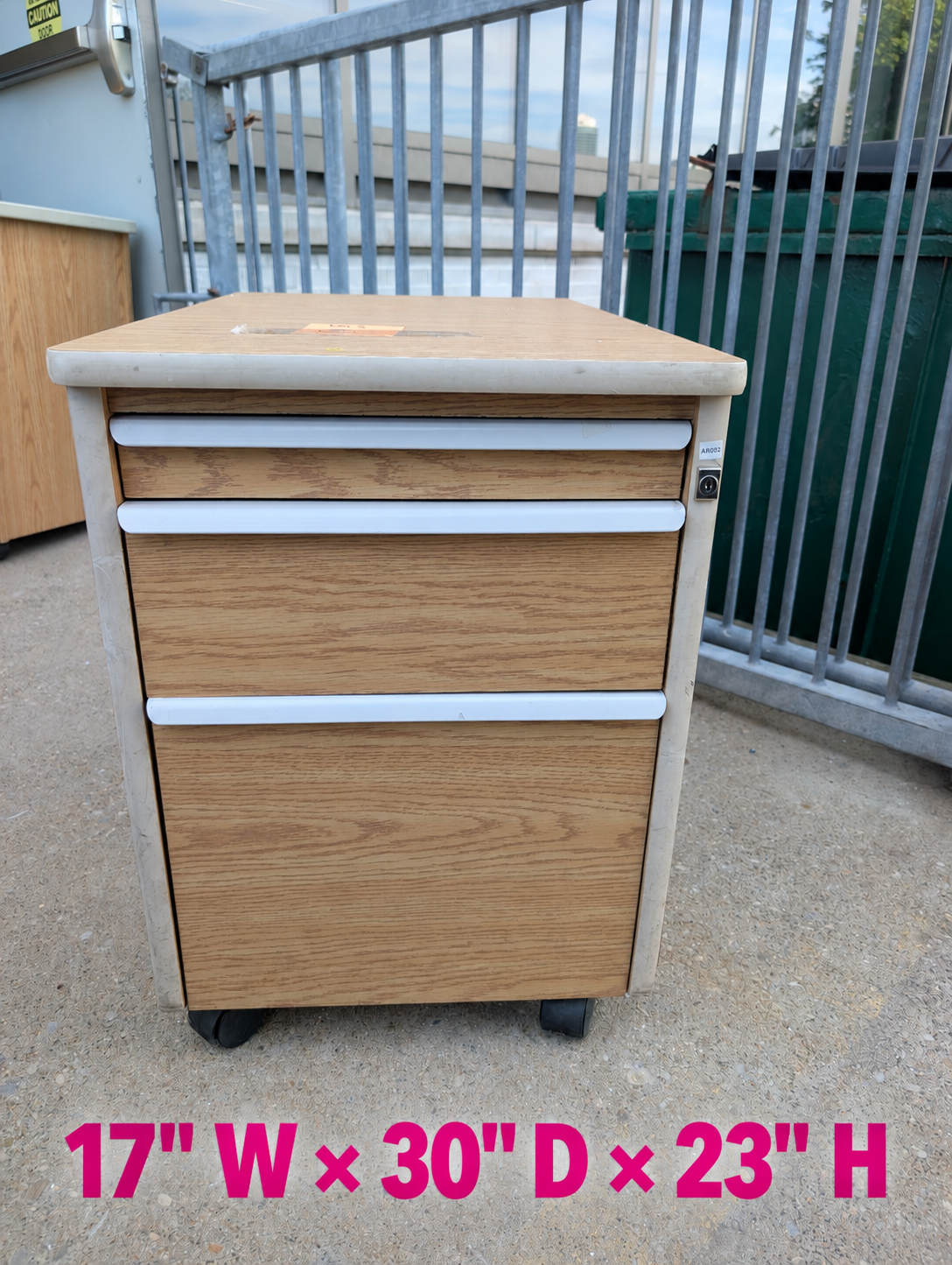17" W x 30" D x 23" H woodgrain under table cabinet