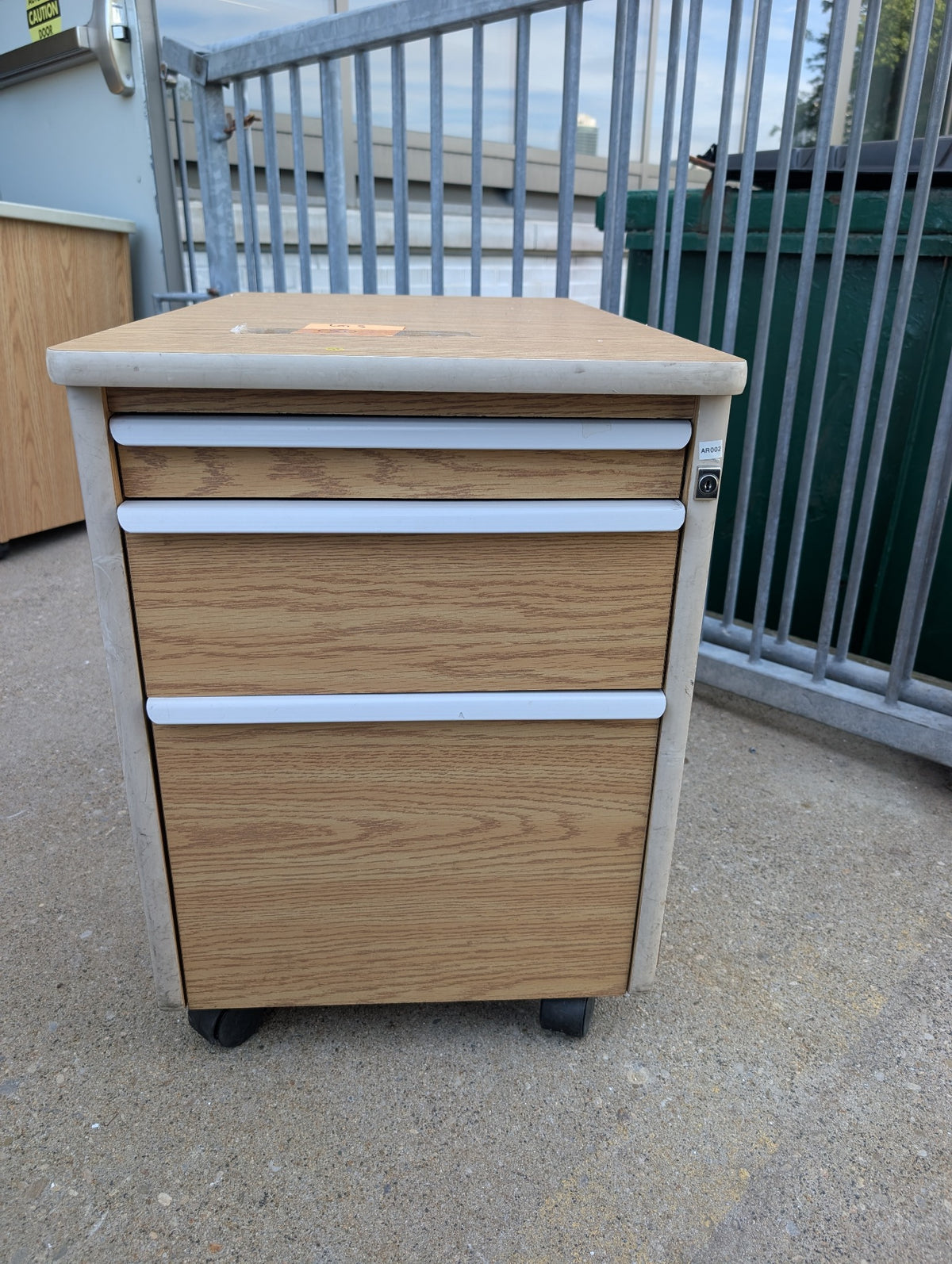 Woodgrain three drawer under table cabinet front view